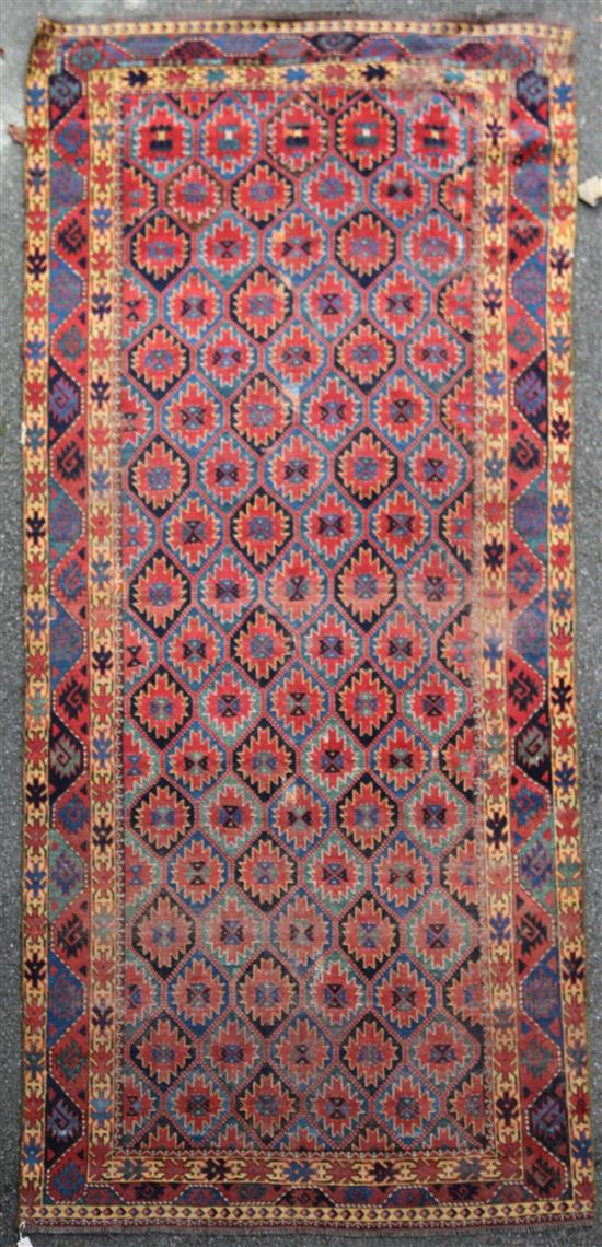 A Caucasian rug, 11ft 2in by 5ft 4in.
